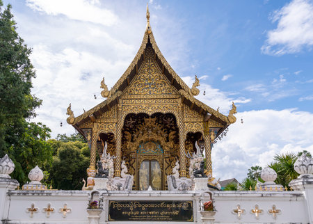 Oct 13 2023 : Wat Pa Dara Phirom Phra Aram Luang. Ornate Buddhist temple complex featuring stone lions and a gilded chedi amid tropical greenery. Chiang Mai, Thailandのeditorial素材