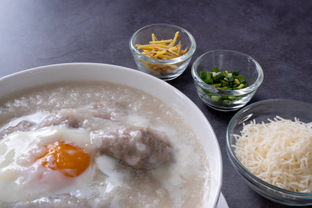 Hot Thai congee (rice porridge) with minced pork ball and boiled egg as breakfastの写真素材