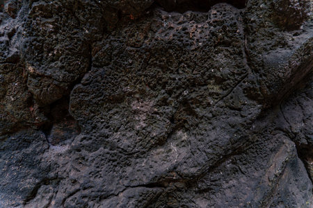 Natural volcanic rock surface displaying unique textures and patterns in a geothermal region during...
