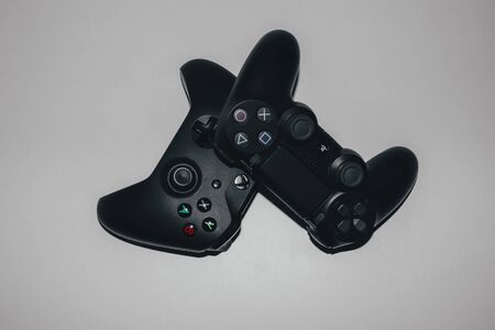 Two game controllers for xbox and playstation on a light backgroundのeditorial素材