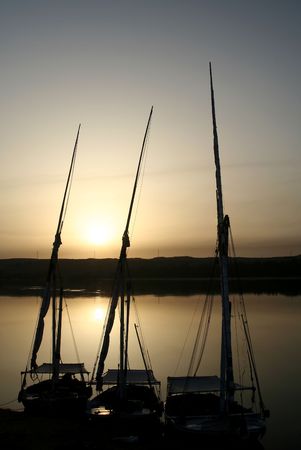 Sunset at Nile River with Feluccas at the river bankの写真素材