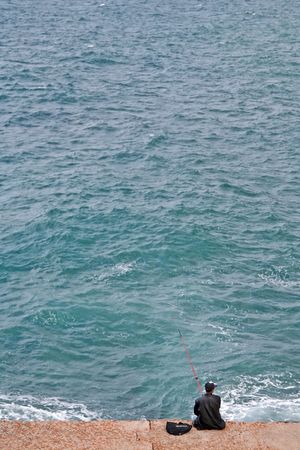 A man fishing at the seaの写真素材