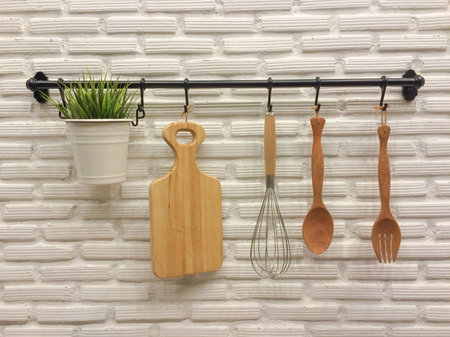 Kitchenware hanging on brick wall.の写真素材