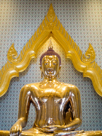 Golden Buddha statue in a temple, Thailand, with a light shining down nicely.の写真素材