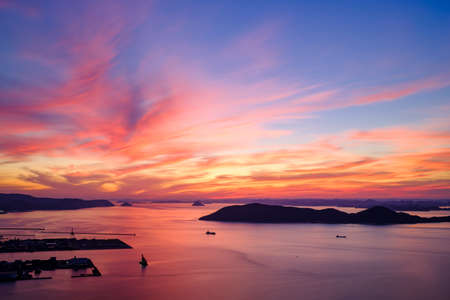 Sunset over the sea and islands in the background. Beautiful seascape.の写真素材