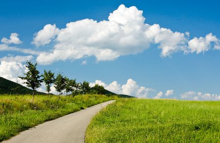 Mountain road and cloudy skyの写真素材