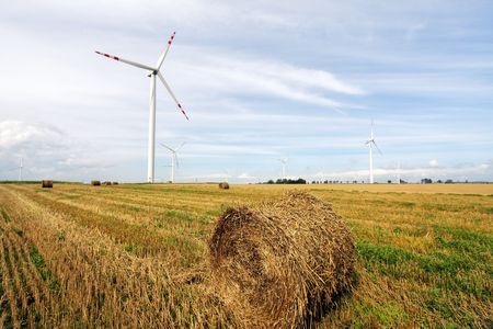 Straw bales and wind turbines farmの写真素材