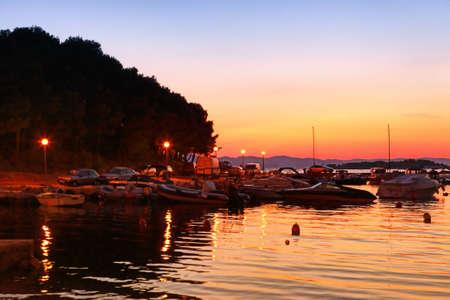 Sailing boats in marina at sunsetの写真素材
