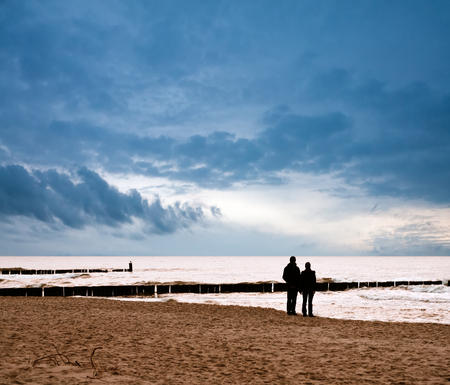 Couple on the beach at sunsetの写真素材