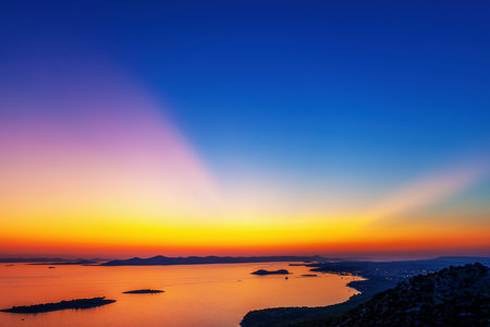 Sunset over the sea with a view of the islandsの写真素材