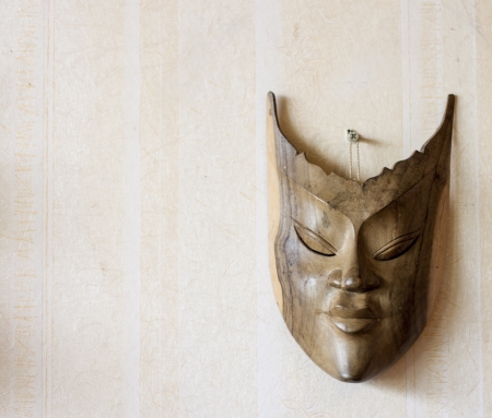 Male Carnival vintage wooden mask on wallの写真素材