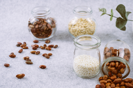 cereals in separate glass container on white backgroundの写真素材