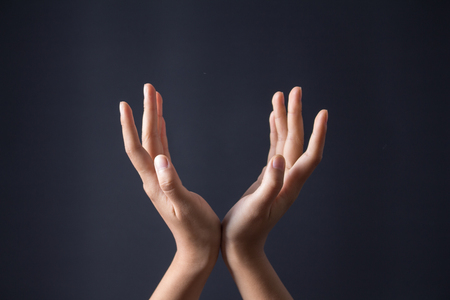 Hand gesture on dark backgroundの写真素材