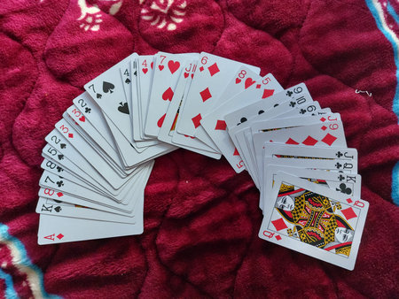 playing cards on a red background, close-up, top view