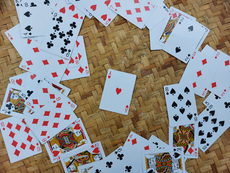 Playing cards on a wicker background. Top view with copy space.