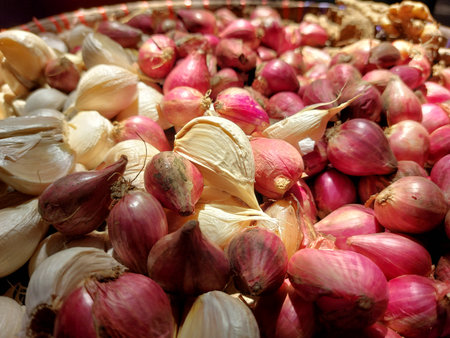 Shallot and garlic in a basket on a market stall.の写真素材