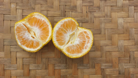 Slices of tangerine on a bamboo background. Top view.の写真素材