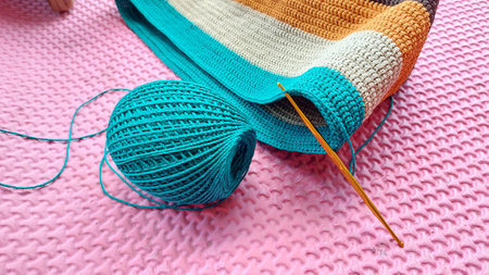Knitting yarn and knitting needles on pink background, closeup viewの写真素材
