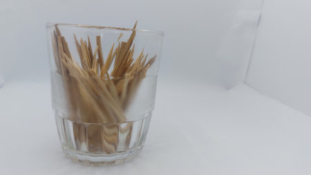 Toothpick in a glass on a white background, close-upの写真素材