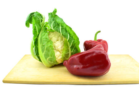 Cauliflower and red bell peppers on a board. Healthy vegetarian food concept.の写真素材
