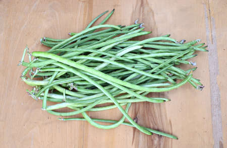 The cowpea (Vigna unguiculata). Fresh long beans on a wooden surface. Healthy vegetarian food concept.の写真素材