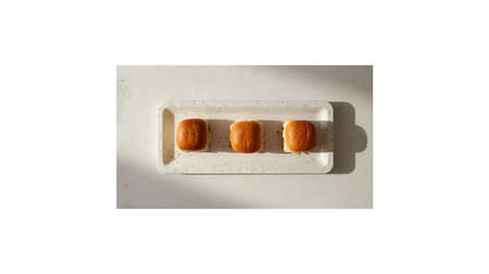 Top view of a marble tray with three cookies isolated on white backgroundの素材