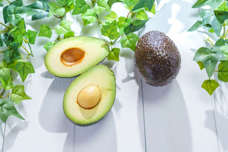 Fresh organic avocado on wooden table