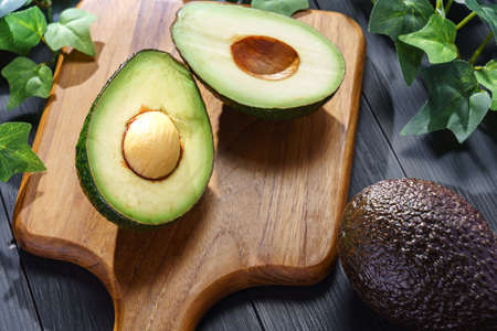 Fresh organic avocado on wooden table