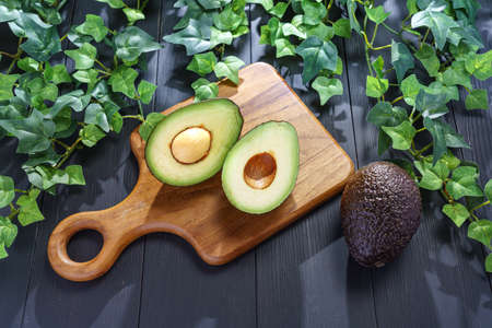 Fresh organic avocado on wooden tableの写真素材