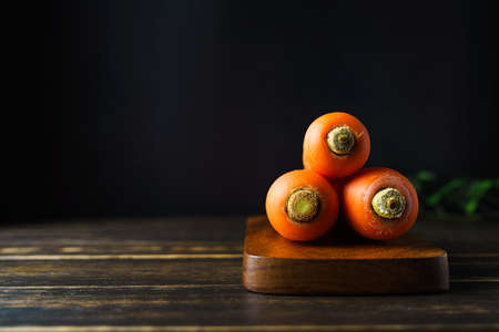 Fresh carrots on wooden tableの写真素材