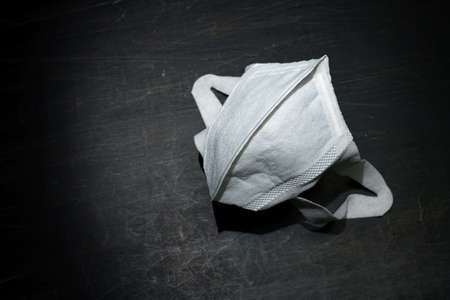 Medical face mask isolated on dark background