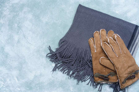 Woolen scarf and gloves on wooden backgroundの写真素材