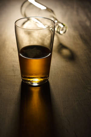 Glass of beer on wooden tableの写真素材