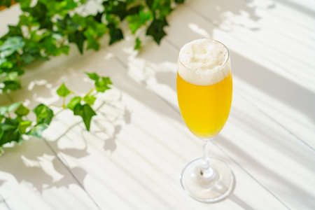 Glass of beer on wooden tableの写真素材