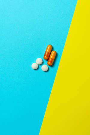 Tablet and capsules supplement on color backgroundの写真素材