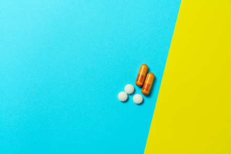 Tablet and capsules supplement on color backgroundの写真素材
