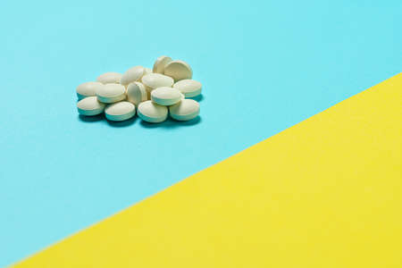 Tablet supplement on color background
