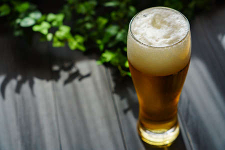 Glass of beer on wooden table