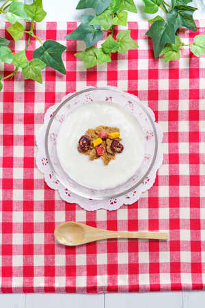 Bowl of fresh yogurt on wooden tableの写真素材
