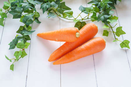 Fresh carrots on wooden tableの写真素材