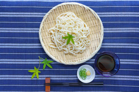 Udon noodle and chopsticks on the tableの写真素材