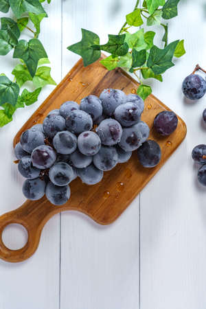 Fresh grapes on wooden tableの写真素材