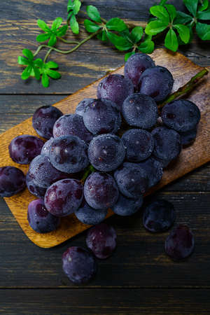 Fresh grapes on wooden tableの写真素材