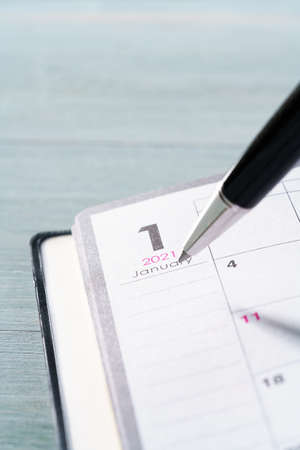 2021 Notebook and pen on wooden background (2021 schedule book)の写真素材