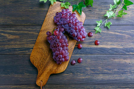 Fresh grapes on wooden tableの写真素材