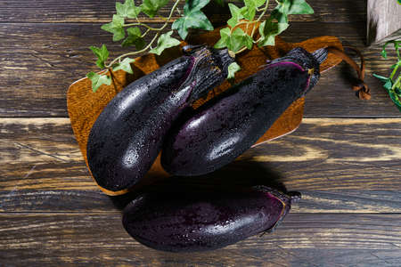 Fresh eggplant on wooden table