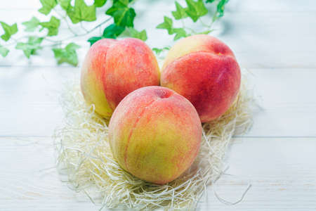 Fresh peaches on wooden backgroundの写真素材