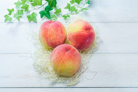 Fresh peaches on wooden backgroundの写真素材