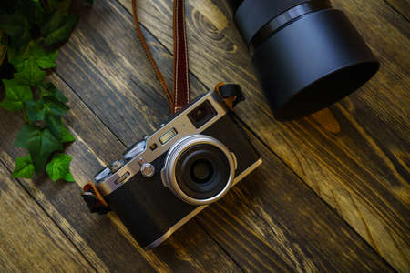 Old style digital cameras isolated on wooden table