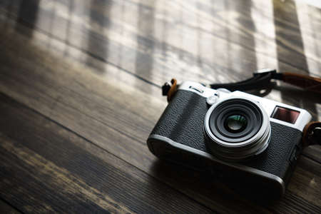 Old style digital cameras isolated on wooden tableの写真素材